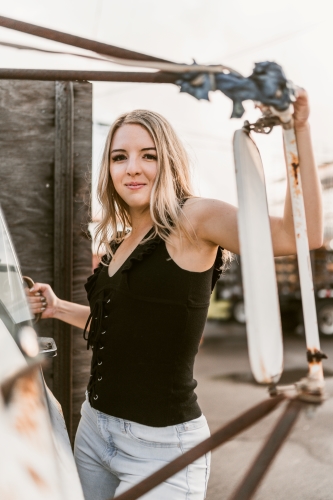 Jessica standing on an old truck posing