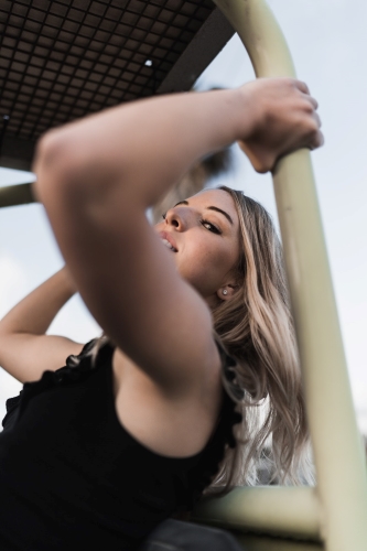 Jessica posing leaning back onto an object